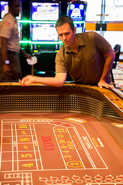 Man playing crabs inside casino at a table