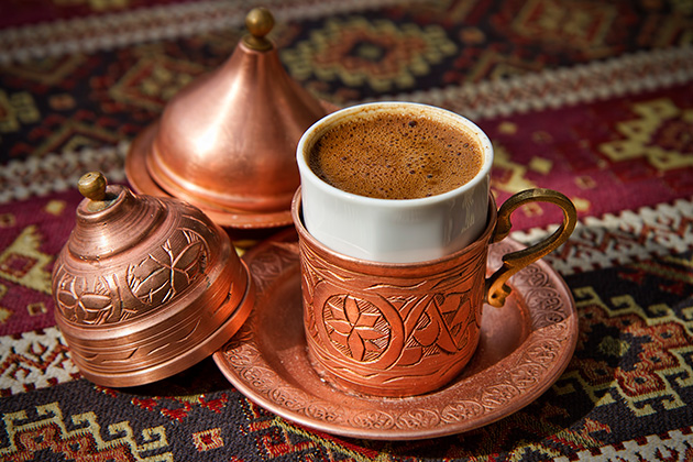 Traditional Turkish Coffee in copper cup holders on a carpet