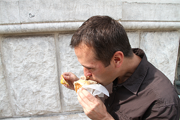 Man eating ice cream out of a bun