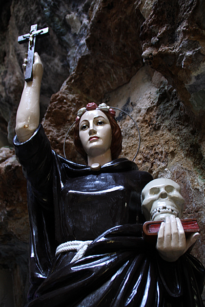 Holding cross and skull