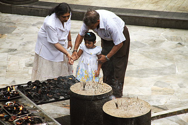 Little girl visiting buddhist temple