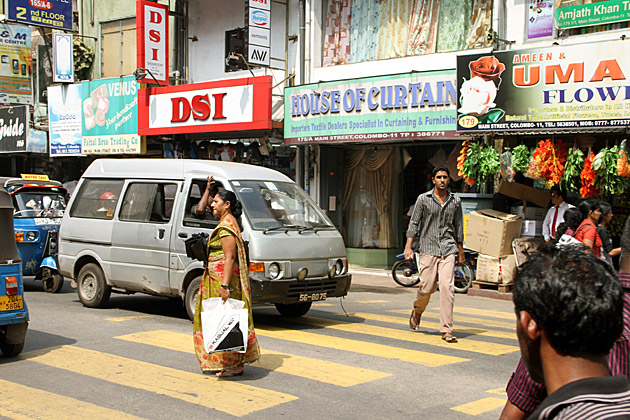 Woman crossing cross walk in Colombo Sri Lanka