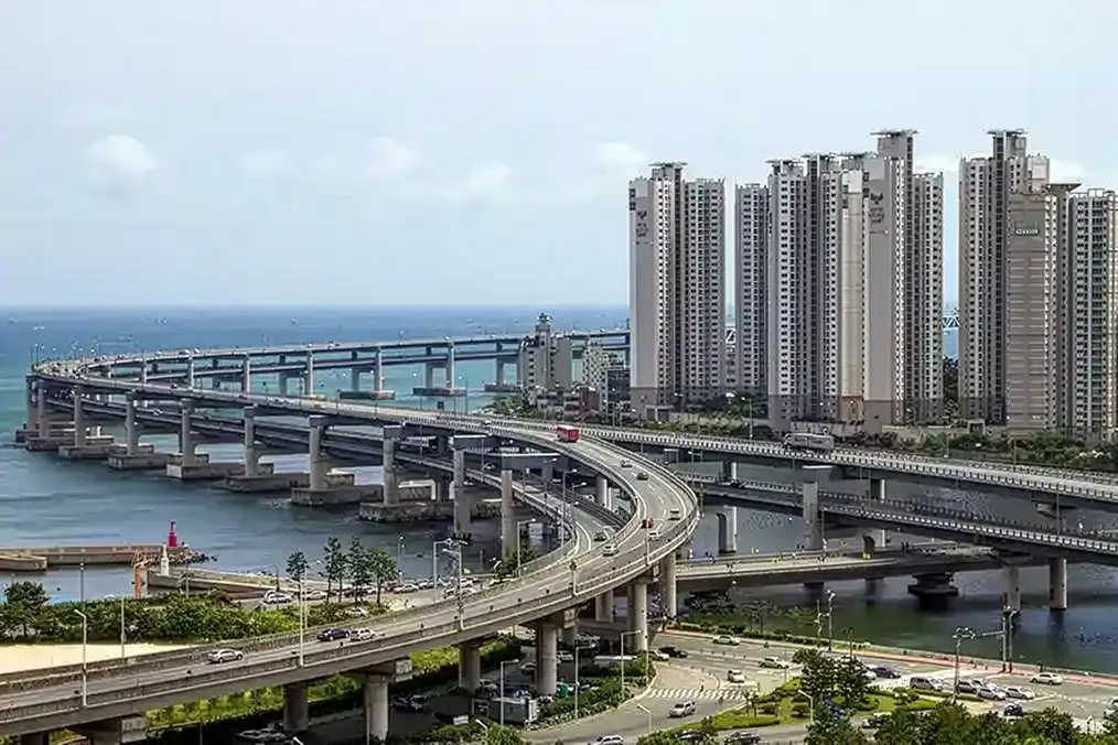 Aerial view of coastal highway bridges and high-rise towers in Busan, South Korea