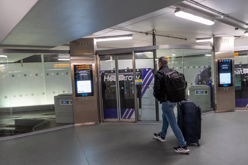 Man with suitcase approaching pod station